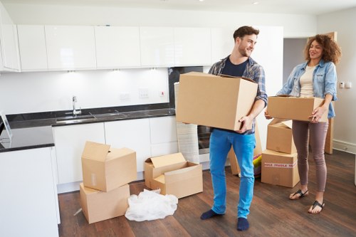 Movers handling furniture in a Clapton property with stairs
